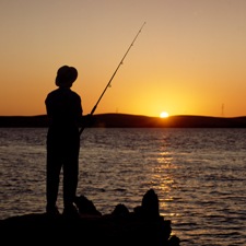 Man fishing in delta waters